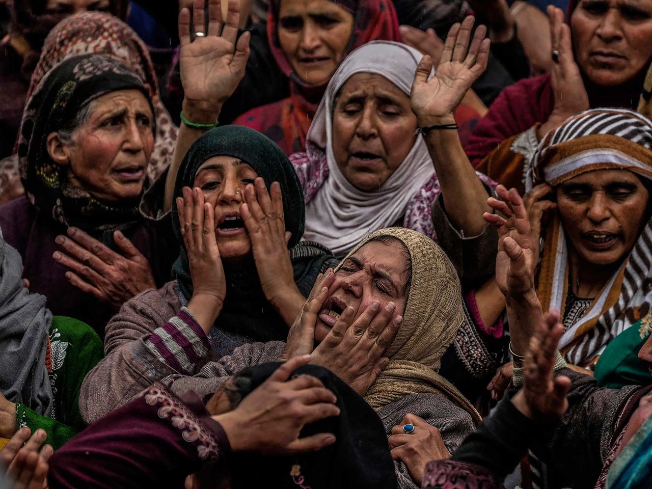 Family members and relatives mourn near the dead body of Rafia Nazir during her funeral in Srinagar, Indian controlled Kashmir, Monday, March 7, 2022. At least two civilians was killed and nearly two dozen were injured when a grenade was thrown in the middle of the crowd at a busy market in Srinagar. This project documents ongoing unrest in the long-disputed region of Kashmir, dating back to 1947, when India and Pakistan gained independence from Britain. Both nations claim Kashmir in its entirety, and each administers a portion of the region. In Indian-administered Kashmir, rebels have been fighting Indian rule for decades, seeking to unite the territory, either under Pakistani rule or as an independent country. India says that Pakistan supports armed insurgency in Kashmir. Pakistan denies the charge, saying it provides moral and diplomatic support only.